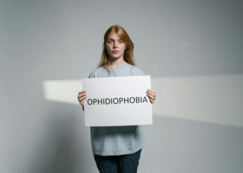 woman holding gold clutch